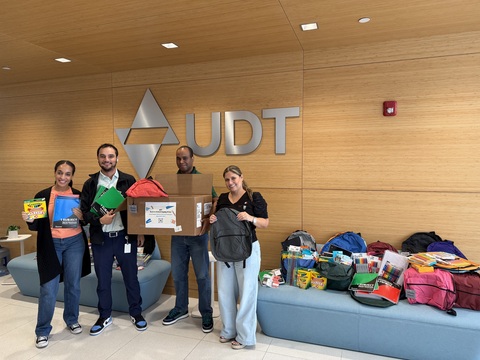 original UDT team members getting ready to take some of their 2026 Back-to-School Drive school supplies to local students.