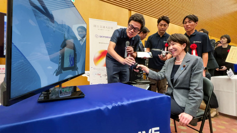 original Japanese Prime Minister Sanae Takaichi visiting the SkyDrive booth