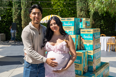 An expecting family celebrates the arrival of their baby at a Pampers community baby shower, where Pampers provided families with Pampers Swaddlers diapers and resources to help prepare for life with a newborn.