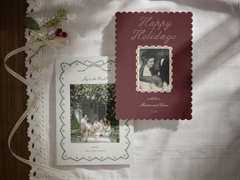 thumbnail Lace-inspired borders, delicate bows and rich burgundy bring a romantic touch to Minted’s 2026 holiday card collection. Shown here is Eloise by Kelly Watkins and Vintage Lace by Rina Ozum. Courtesy of Minted.