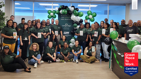 Longbridge Financial employees, joined by CEO Chris Mayer (left of center banner), hold cards with messages of connection and encouragement for older adults served by Meals on Wheels programs during a volunteer event at the company's Houston office on Sept. 16, 2026. Longbridge became a corporate partner of Meals on Wheels America in 2026.
