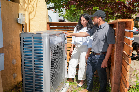 original An HVAC contractor speaks to a customer about a heat pump. Credit: Building Decarbonization Coalition (BDC)