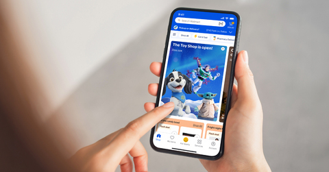 original Someone holds a phone displaying the Toy Shop in the Walmart app.