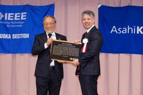 original Toshio Fukuda, Former President and Life Fellow of the IEEE, presents the IEEE Milestone plaque to Naoyuki Kurita, President of Asahi Kasei Microdevices