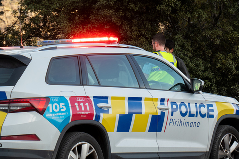 original New Zealand police officer interviews a person involved in a collision.