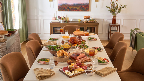 The 2026 Sam's Club Thanksgiving meal is displayed on a festive dining table, showcasing the many dishes included in the meal.