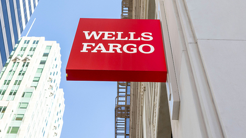 Wells Fargo red sign displayed on a city building exterior