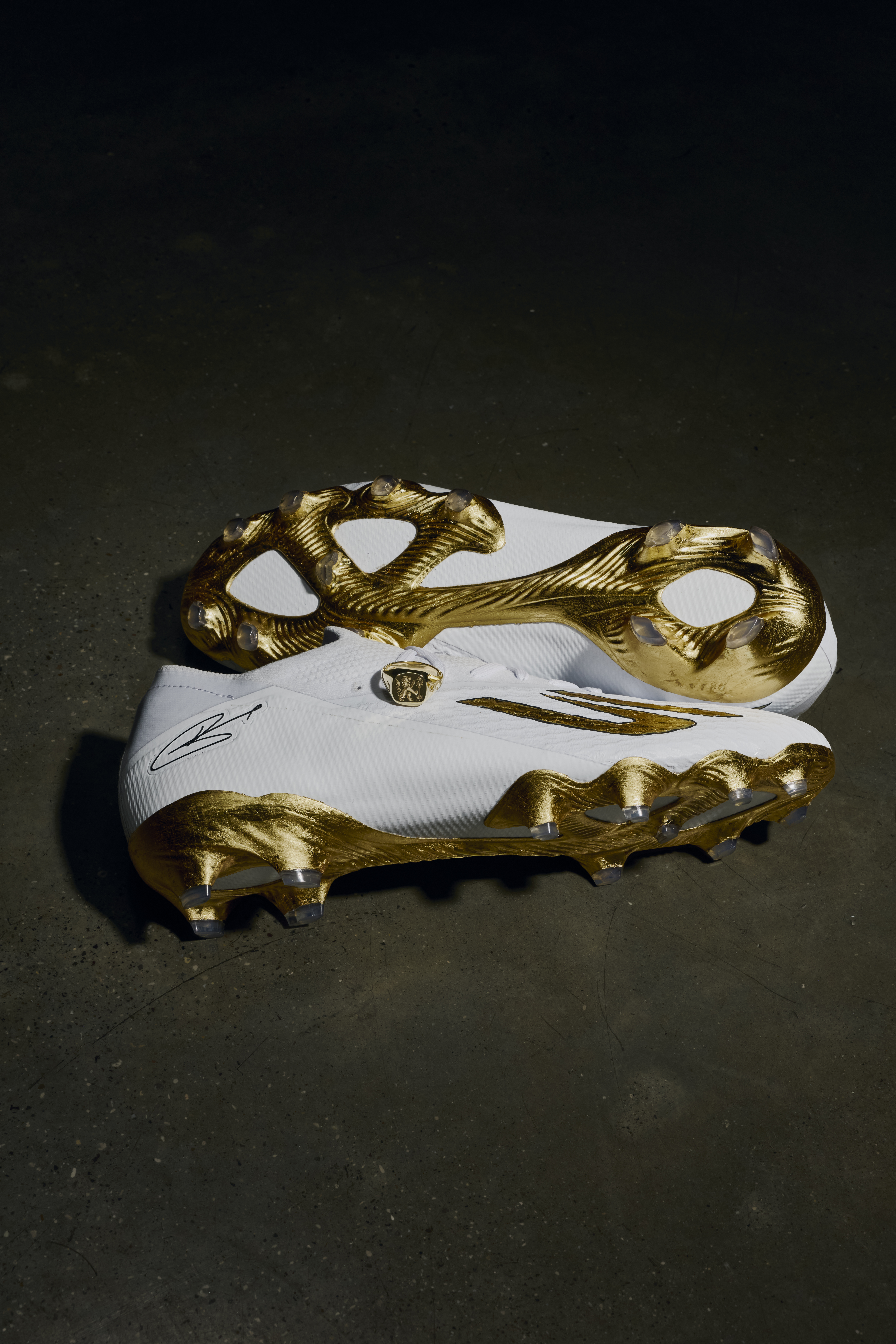 A golden occasion that deserves a golden gift u2013 the bespoke gold signet ring sits atop Skechers limited-edition u201cMark of Greatnessu201d boot.